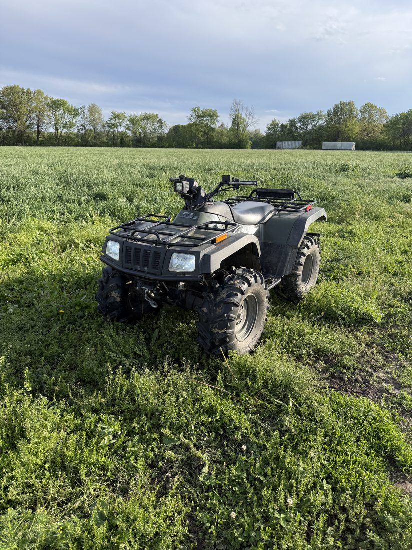 Black Arctic Cat 400 ATV with front LED light pod mounted on the handlebars